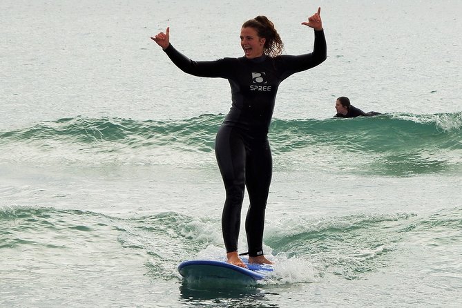 Beginner Surf Lesson at Te Arai Beach - Taking the board into the water