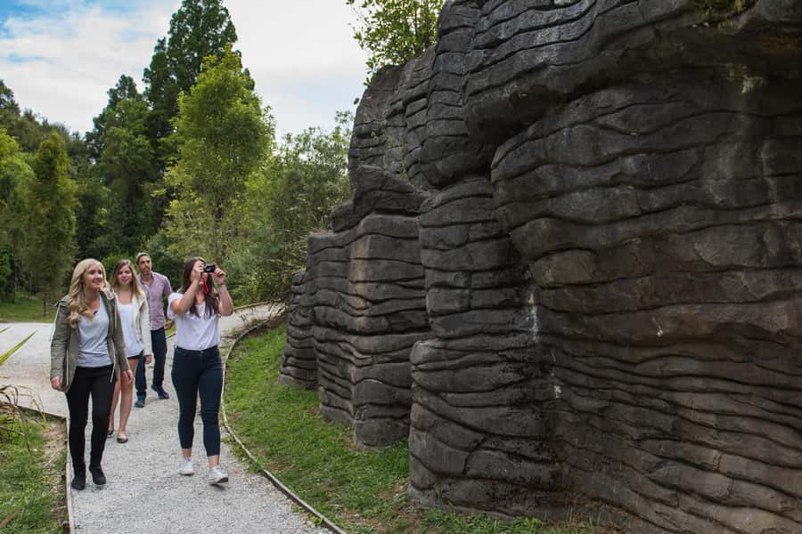 From Auckland: Waitomo Glowworm and Ruakuri Caves Day Tour - Ruakuri Cave, limestone folds, and distant waterfalls