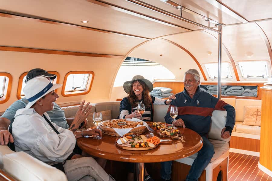 Lake Taupo: Luxury Sailing Catamaran to Māori Rock Carvings - Sailing back with a drink and a view