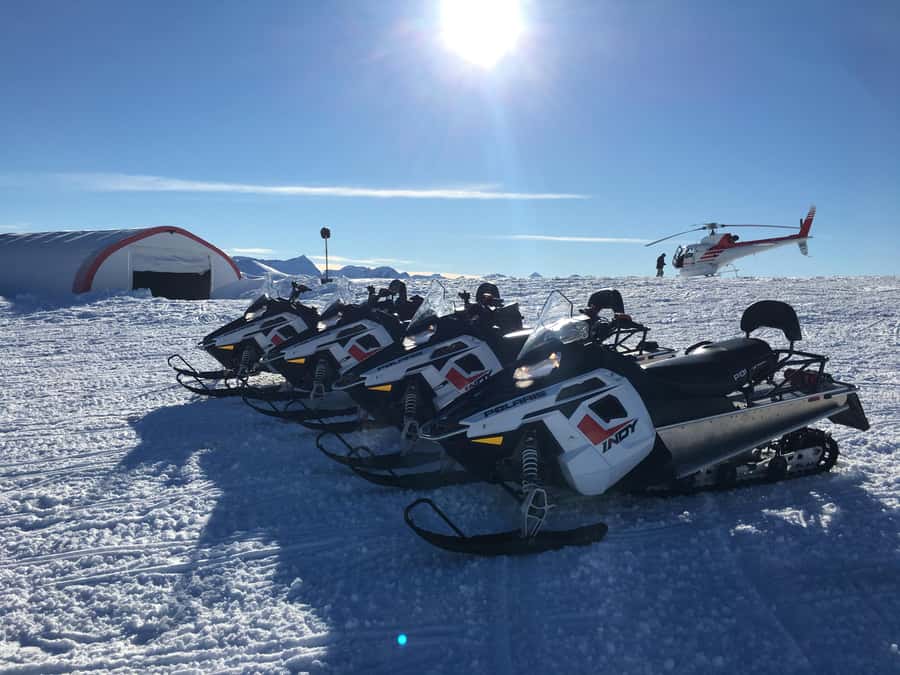 Queenstown: Snowmobiling Experience with Helicopter Flight - Riding a Snowmobile in the Garvie Range