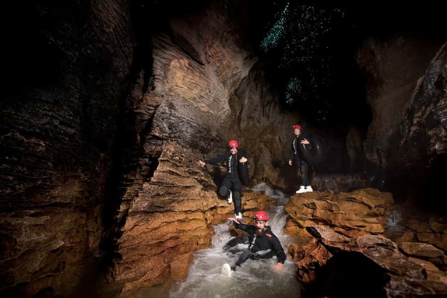 Waitomo Caves Black Abyss Ultimate Caving Experience - Black-water rafting and underground waterfalls